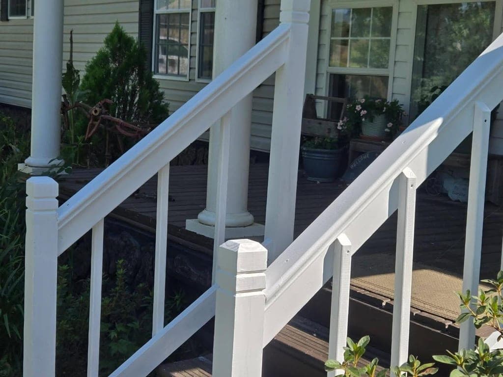 Newly repaired white porch railing and steps